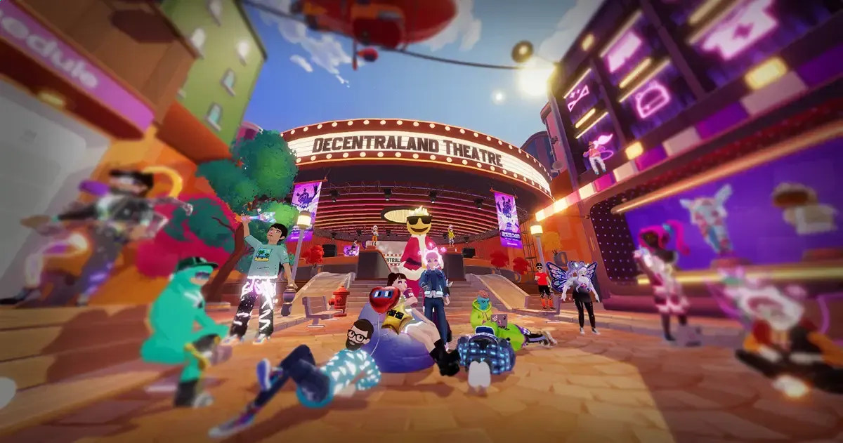 Colorful avatars gathered in a plaza outside the illuminated Decentraland Theatre